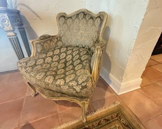 Pair-  French provincial Louis XV style  bergere armchairs -cabriole legs.  Tapestry style fabric w/ muted gold/beige base. 