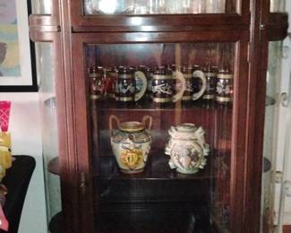 Antique Display Cabinet with Decorative Vases and Bottles