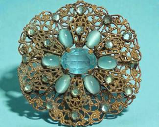 Edwardianstyle filigree metal brooch with aquablue stones