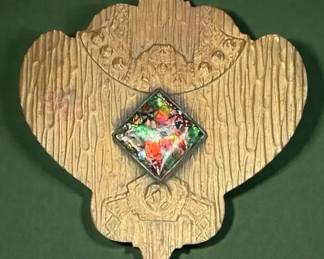 Goldtone brooch with a multicolor central stone