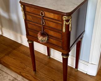 A late 19th C French walnut marble lined chamber pot stand