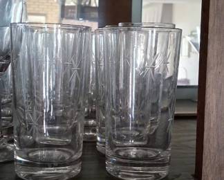 vintage highball glasses, likely from the mid-century era, featuring etched atomic starburst or pinwheel designs