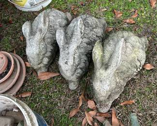 Three large concrete bunnies.