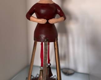 Susan de Generes (American, Contemporary)
Female Figure with Bells. Mixed Media (Wood, Metal, Painted Surface). Early 21st century Measures 17" H x 8" D.  Photo 1 of 2. 