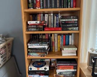 Assorted Collection of Books on a Wooden Bookshelf