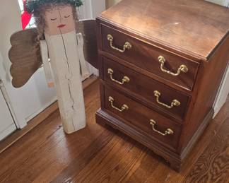 small chest of drawers and decorative angel 