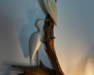
hand-carved wooden egret sculpture mounted on driftwood. 

