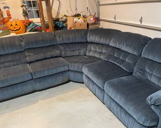 Blue sectional couch with recliners on ends