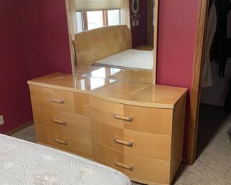 Dresser with mirror that matches two nightstands and a queen size bed