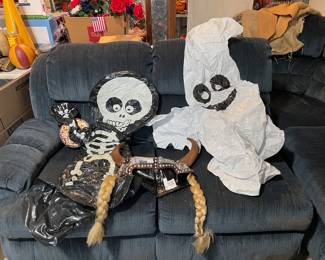 Blue sectional and two of the Halloween blowups and a “helmet” with braids