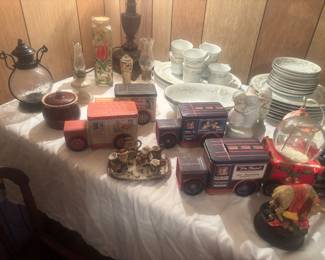 Several dish sets and tins. Lots of music boxes and snow globes 