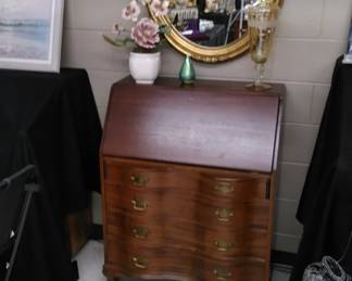 Mahogany drop-front secretary with serpentine front, gold wall mirror