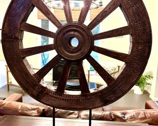 Rustic cart wheel on stand