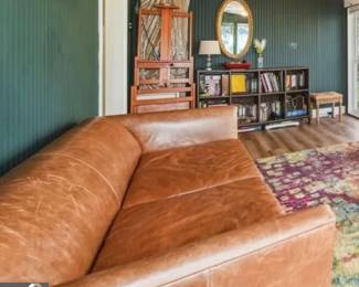 Leather Sofa, Artist's Easel, Books, Lamp