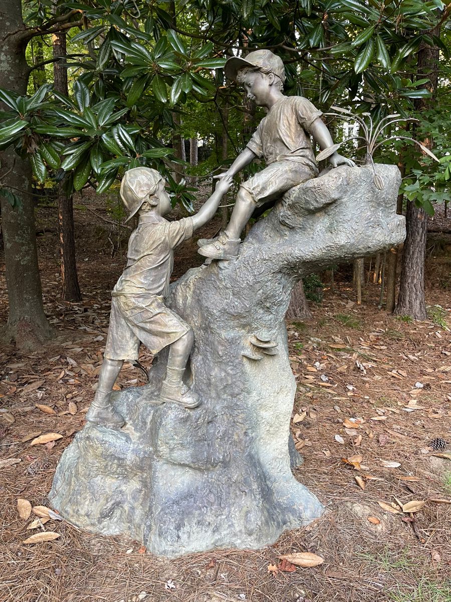 Bronze sculpture of two young boys playing on a rock formation. This is a huge piece of art 6 feet  3 inches tall and it is about 4 feet 5 inches wide. This is a rare piece that we WILL presell because of the size and unique nature.  Contact us for details. 