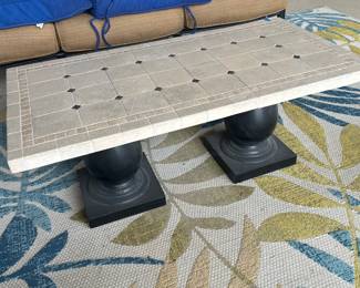 Outdoor table and rug.  