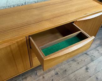 This lot features the Orvar sideboard by Scandinavian Designs. Crafted in teak, this cabinet measures, 29.5” H x 66” W x 20” D. Three large drawers and two cabinets provide ample space for hosting and dining accoutrement.

