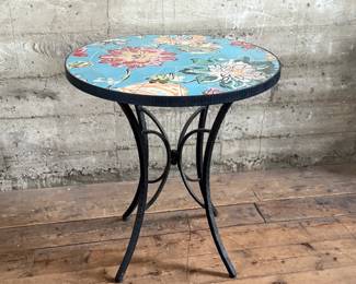This lot features a Kai Flower mosaic table that measures, 30” H x 28” W x 28” D.

