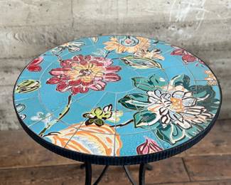 This lot features a Kai Flower mosaic table that measures, 30” H x 28” W x 28” D.


