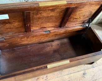 This lot features a modern provincial style flip top trunk, made of mango wood. This chest measures, 17.5” H x 51” W x 18” D.

