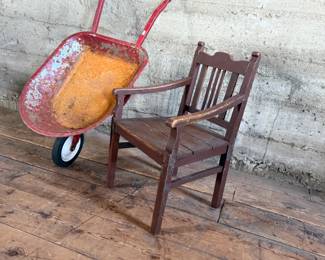 This lot features an antique children’s chair and child’s size wheelbarrow.

