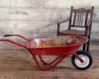 This lot features an antique children’s chair and child’s size wheelbarrow.

