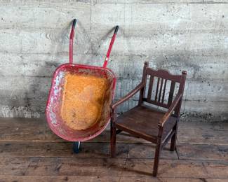 This lot features an antique children’s chair and child’s size wheelbarrow.


