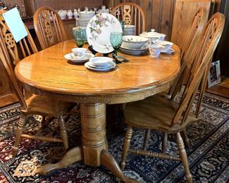 Solid oak dining table - includes 8 chairs and 2 large leaves.