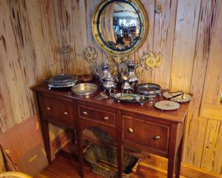 Gold framed round convex antique mirror, Reed & Barton Silver tea set with various other pieces on Beautiful inlayed sideboard.