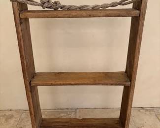 Hanging bookshelf made from antique adobe brick molds