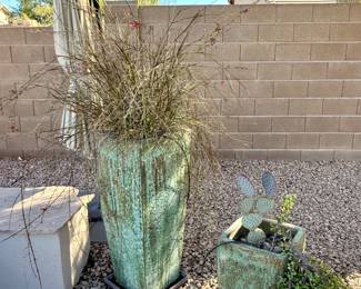 Potted desert plants and lots of large to medium to small  ceramic and stone pots.