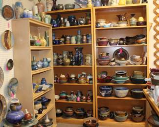 More plates on the wall and more pottery on shelves