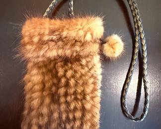 Small fur purse with leather strap.