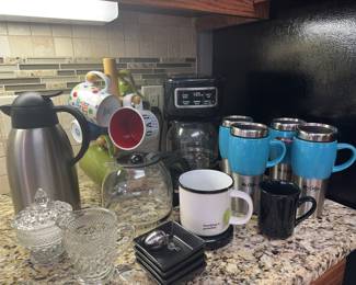 Coffee Collection Summary
• 10 Mugs & Drinkware: Includes 4 Mr. Coffee travel mugs, 4 assorted ceramic mugs on a tree, 1 large white inspirational mug, and 1 small black mug.
• 3 Coffee Preparation Units: Includes 1 Mr. Coffee machine and 2 glass carafes.
• 6 Serving & Accessory Pieces: Includes 4 small black square dishes, 1 ornate glass sugar bowl with lid, and 1 ornate glass creamer. Tea strainer.&nbsp;
&nbsp;
&nbsp;