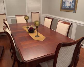 Beautiful dining room table with inlaid wood design. Eight matching chairs plus two leaves, high-quality set.&nbsp;
No scratches, scuffs, or stains noted.

Table is 44 inches wide, 30 inches tall, and 86 inches with one leaf.

Decor on table and ficus tree included.