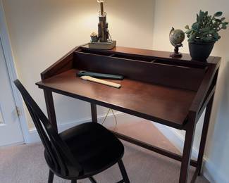 Writing desk with storage nooks and monitor ledge. Chair, lamp  and art included. Yes, that's a slide rule!