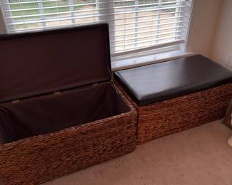 Two lined wicker storage chests with cushion lids.