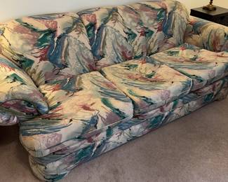 Comfy vintage couch with rolled arms.