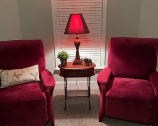 Pair of red leather recliners plus red slipcovers, occasional table and lamp. Leather is worn but not torn.