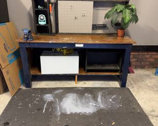 Garage workbench with pegboard rear, built-in vise, work mat