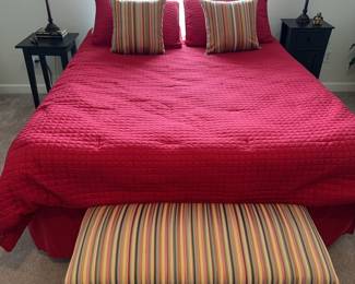 Full size bed with comforter and footstool. Serta mattress.