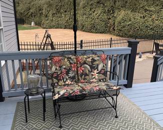 Wrought iron loveseat glider with umbrella and side table. Cushions included. Rug Included.