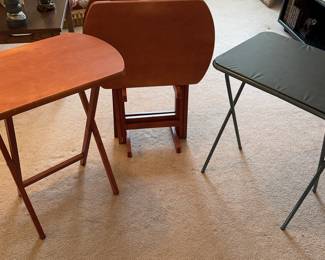 TV trays. 4 wooden ones on a storage stand. 1 blue vinyl vintage one.