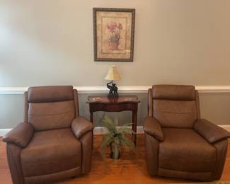 2 tobacco brown rocking recliners, measures 38"x38"x40" (60" reclined)
Floral art 25"x31" tall
2 drawer console table 32"x16"x31"
Elephant lamp 20”
Faux fern in vase 21"x20"
