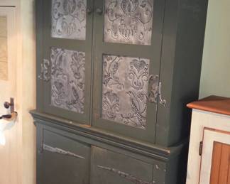 Vintage step-back cupboard/pie safe with punched tin panels and surface-mounted decorative strap hinges                  Kitchen dining storage cabinet panty with perforated aluminum designs.                              Primitive  American Farmhouse Rustic and French Country