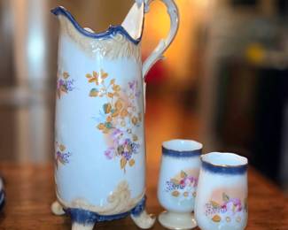 Antique floral footed porcelain pitcher and pedestal tumbler set.  
