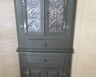 Muted green corner cabinet.