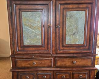 Tall wooden Sapnish style bar cabinet dining hutch with slate door accents. Wine/bottle storage and stemware racks.