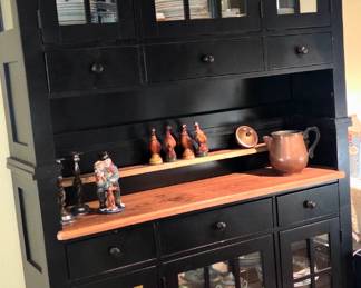 Two lighted black glass door dining buffet with butcher block stacked creating a dining hutch.
