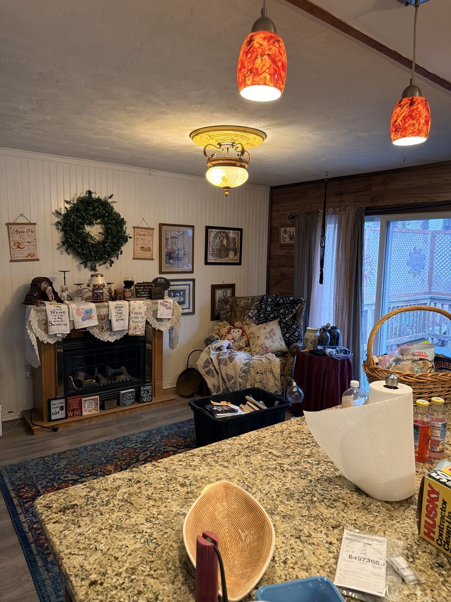 Fireplace, wall decor, various decorative items, chair.